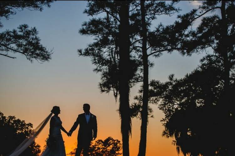 06 bride and groom holding hands at sunset